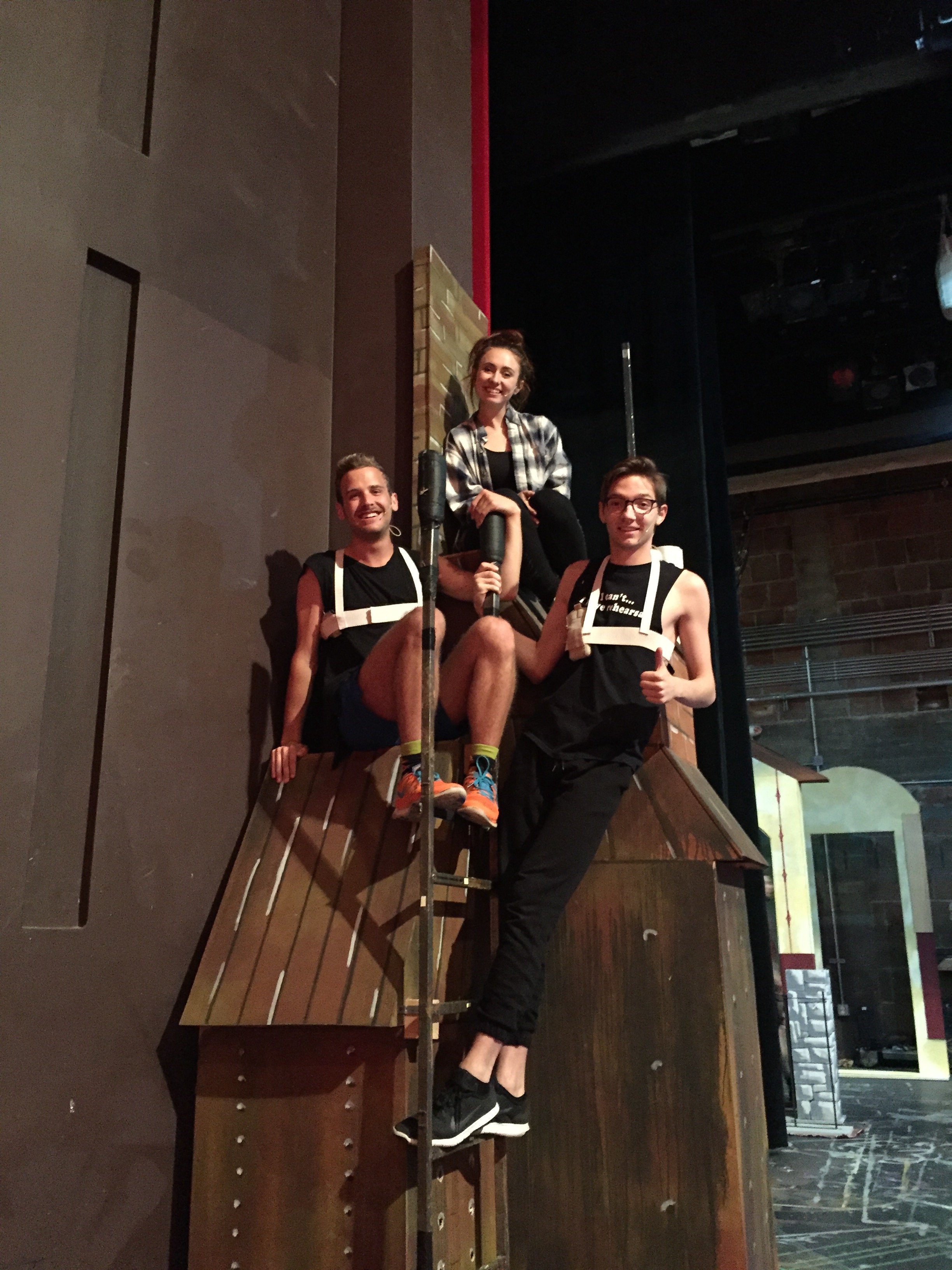 Kable, Savannah, and Nicholas, the three founders of Pure Imagination, on a stage set staircase