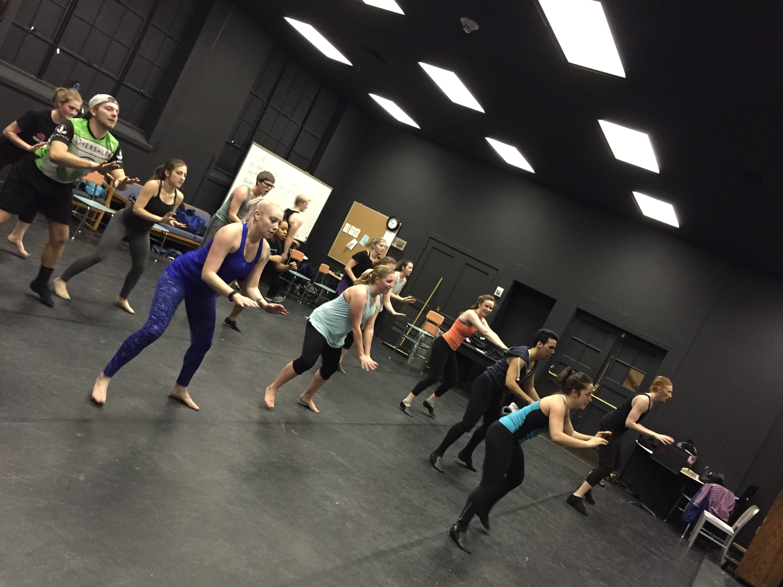 Group dance rehearsal in a black studio